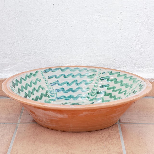 A Spanish Fajalauza lebrillo pottery bowl from Granada, hand-painted in green over a cream glaze, a large ceramic wall art...