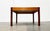 Square mid-century coffee table in teak and walnut. A design with a striking combination of materials. The table is...