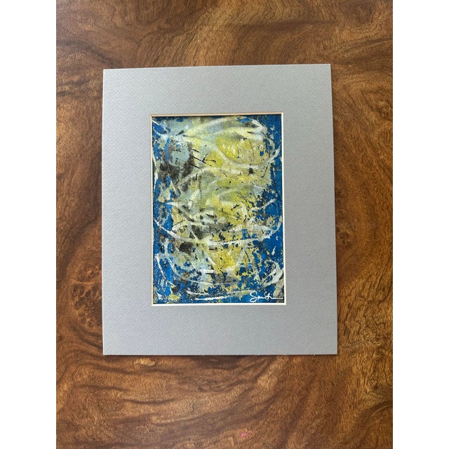 An original abstract mixed media painting exploring movement, texture, and light through layered blues, soft yellows, and...