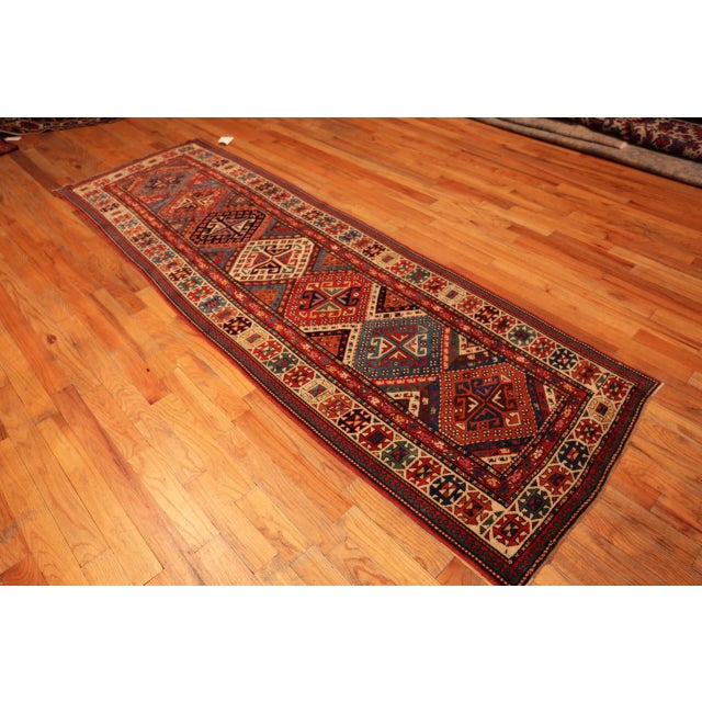 Striking Anitque Kazak Runner Rug with Bold Tribal Geometry and Vivid Village Charm, Country of Origin: Caucasus, Circa...
