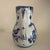 The Delft pitcher features a cobalt blue floral design. The pitcher is marked "JT" for Joost Thooft, which is the historic...