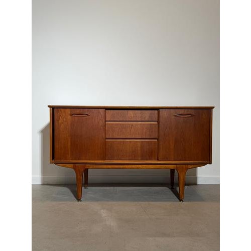 A beautifully proportioned mid-century modern sideboard by Jentique, crafted in richly figured teak and showcasing the...