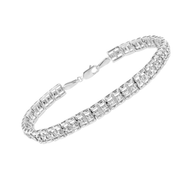 This lovely sterling silver bracelet features 1/10 cttw of beautiful, natural diamonds. The design of this piece features...