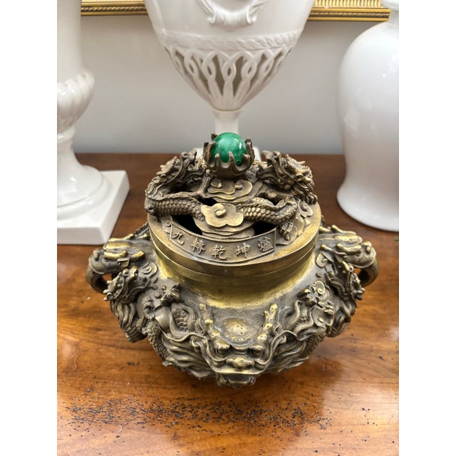 Or are antique or vintage cast brass incense burner with dragons and fu dogs. Green stone finial could be jade, not sure....