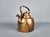 A solid copper tea kettle was hand made around 1870. It features hinged lid on spout. It shows wear expected from the age,...