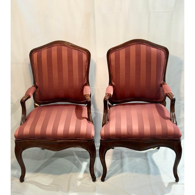 An elegant pair of Louis XV style armchairs by Beverly Furniture Manufacturing Company of Pico Rivera, California. Each...