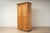 An antique wardrobe made of solid pine, originating from Germany and dating to the late 19th century. The wardrobe offers...