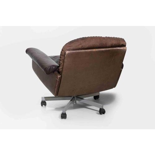 A substantial and highly comfortable mid-century modern swivel lounge chair, featuring a generous, low-slung form...