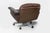 A substantial and highly comfortable mid-century modern swivel lounge chair, featuring a generous, low-slung form...