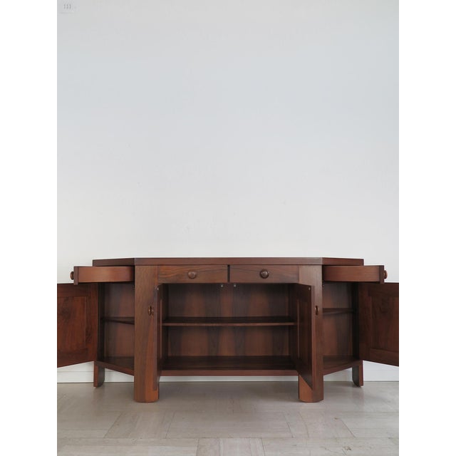 Sideboard designed by Silvio Coppola for Bernini in the 1960s, trapezoidal in shape, made of walnut, featuring...