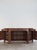 Sideboard designed by Silvio Coppola for Bernini in the 1960s, trapezoidal in shape, made of walnut, featuring...