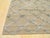 A handwoven wool flatweave, made in India and measuring 6' x 9'. Geometric drawing across the field. Flatweaves carry no...