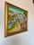 A stunning Haitian village scene by Louines Mentor, expertly captured in oil on canvas. The composition is filled with...