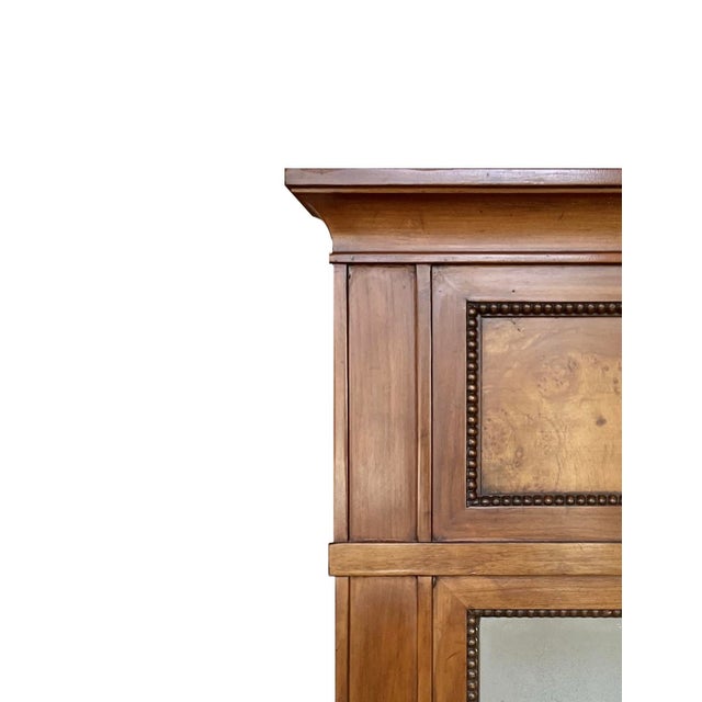 Elegant and understated, this vintage fruitwood mirror has a wonderful architectural presence. An upper frieze of burled...