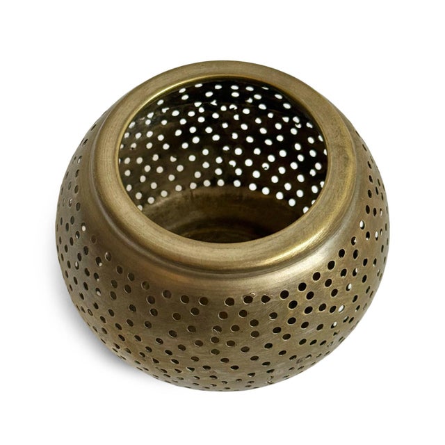 Vintage nickel ball candle holder with perforated holes. Makes an elegant glowing effect when lit with a tea light candle....