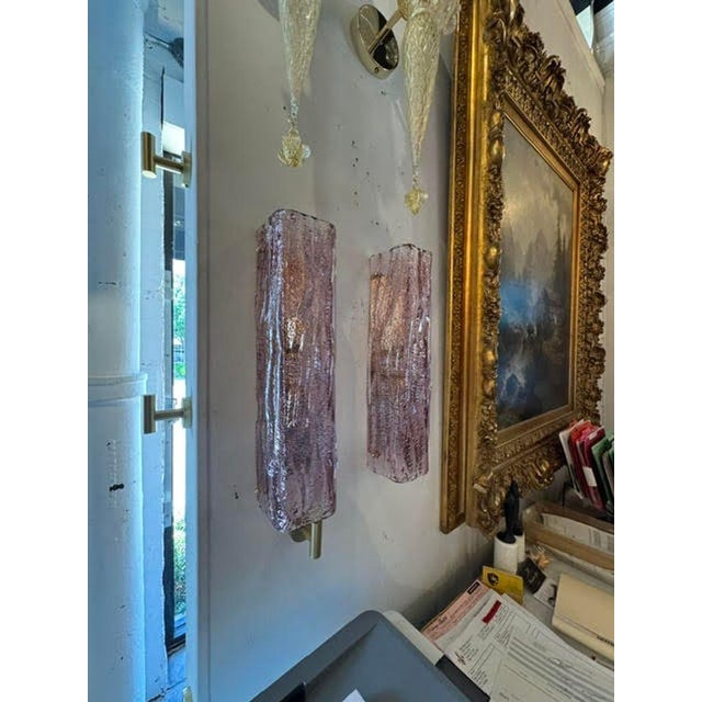 The Murano Lavender Granola Glass Sconces are beautifully designed wall fixtures that add a touch of elegance to any room....