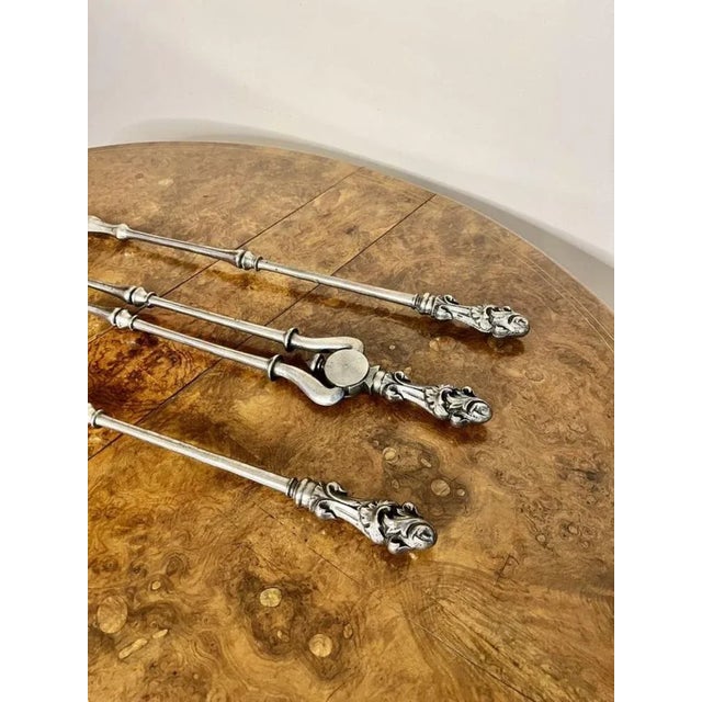 Quality set of antique George III steels fire irons having a quality set o fire irons consisting of a shovel, poker and a...