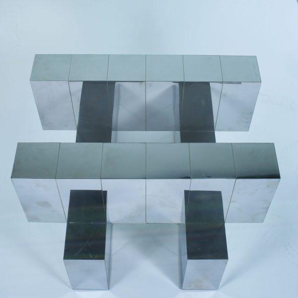 A chrome coffee table in the Cityscape manner attributed to Paul Evans, its patchwork of polished chrome panels reading...