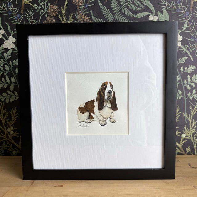 This original watercolor captures the gentle, soulful expression of a classic basset hound. Painted with soft, natural...
