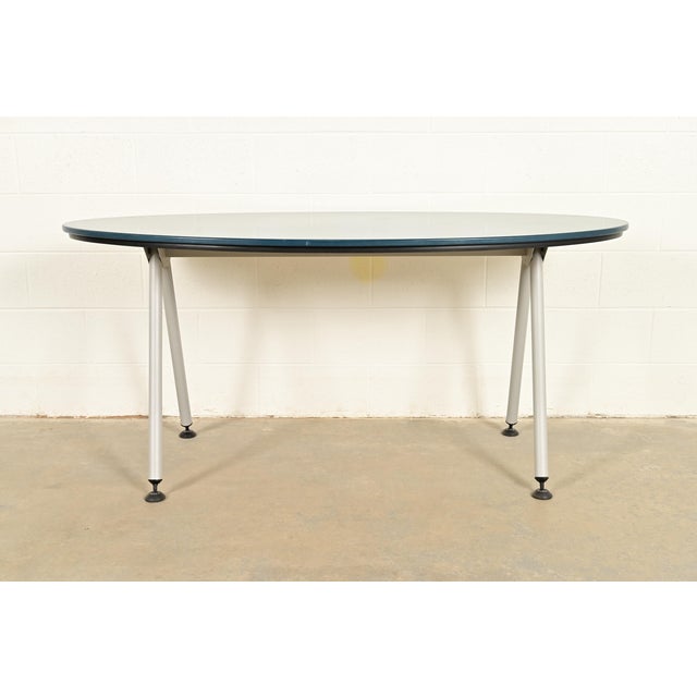 A sleek and stylish Modern or Mid-Century Modern oval dining table or library table In the manner of Herman Miller By...