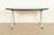 A sleek and stylish Modern or Mid-Century Modern oval dining table or library table In the manner of Herman Miller By...