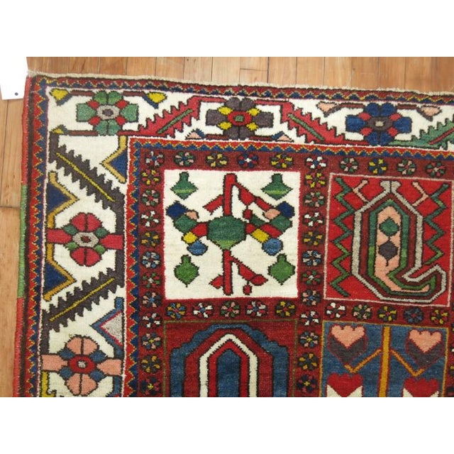 Colorful Persian Bakhtiari carpet with traditional panel design. The weaver added colorful salvage to each side too giving...