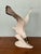 Decorative Statue depicting a Seagull in Porcelain Produced by Royal Dux Czechoslovakia in the 1950s. The brand is placed...