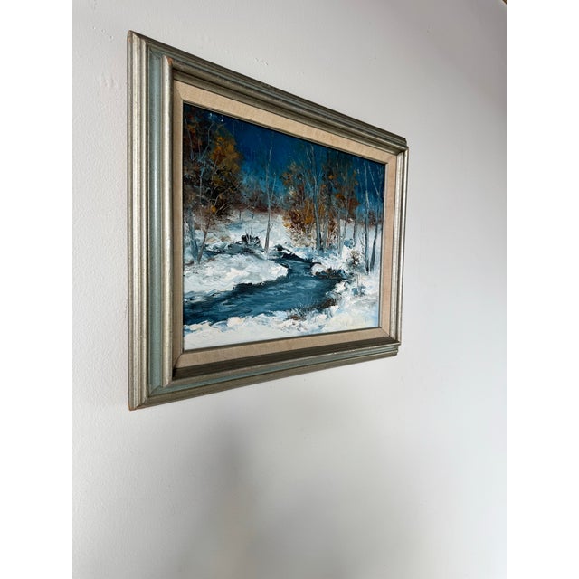 This serene vintage oil painting by V. Janousek beautifully captures a winter landscape in the Impressionist style. The...