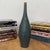 "About This Piece About This Piece Bring drama and artistry into your space with this striking tall vase. Its surface...