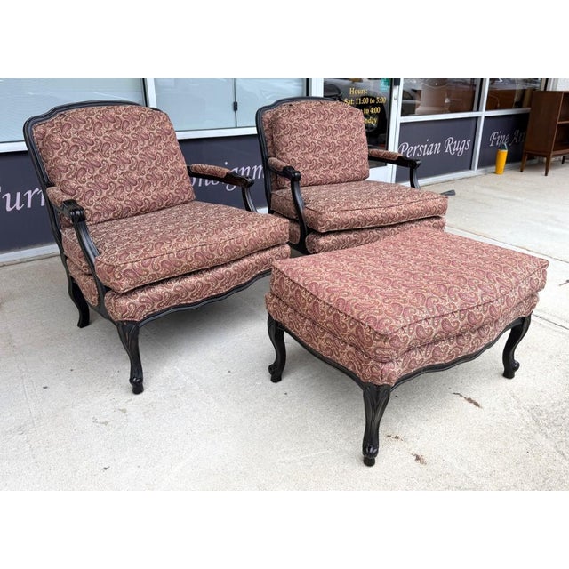 This elegant pair of Fairfield fauteuil chairs features dark carved wood frames, gently curved arms, and plush cushions...
