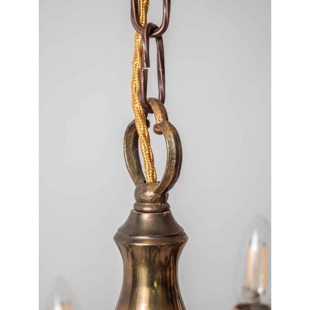 Larger two-story chandelier of the dutch type with arms decorated with fish. The chandelier is made of brass and is...