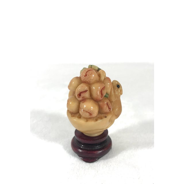 A very charming carving of a little mouse on a basket of auspicious peaches on a Chinese style round wood stand. Very...