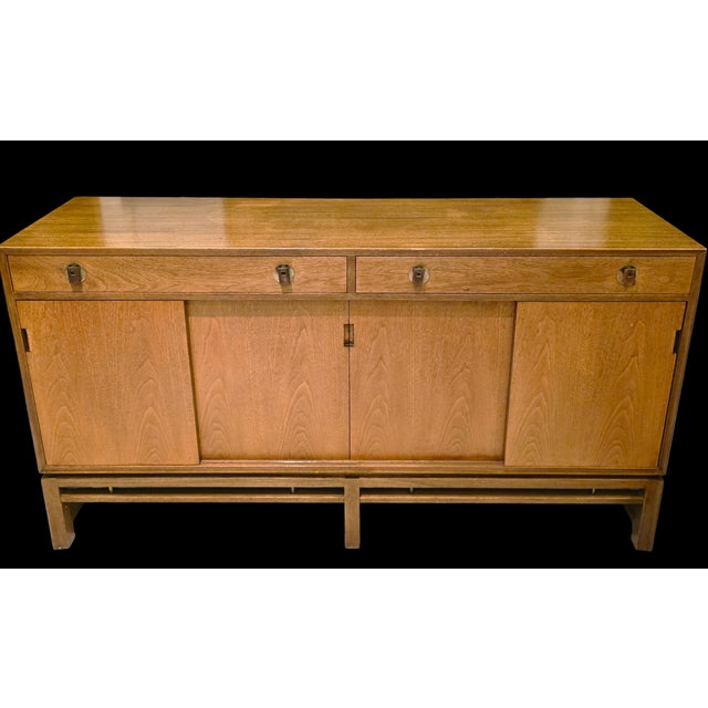 This Edward Wormley for Dunbar Sideboard, a refined mid-century, American modern storage cabinet with substantial form...