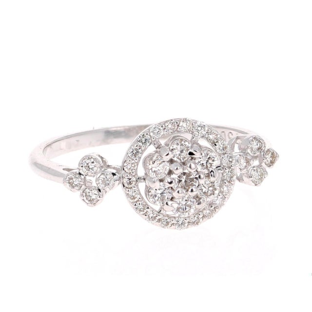 A cute and dainty diamond cluster ring! The ring has 36 Round Cut Diamonds that weigh 0.43 Carats. The clarity and color...