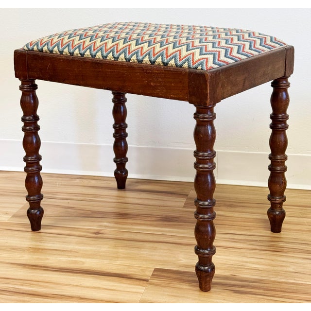 Vintage turned wood leg stool featuring padded inset seat with vibrant zig zag upholstery. Stunning patina to wood frame....