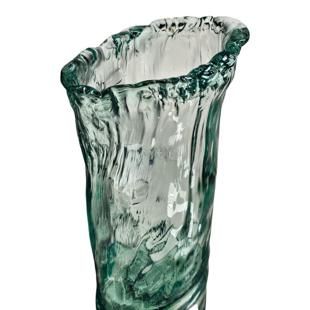 A vessel born of sea and sand, this recycled glass vase bears the strength of authenticity and the delicate whisper of...