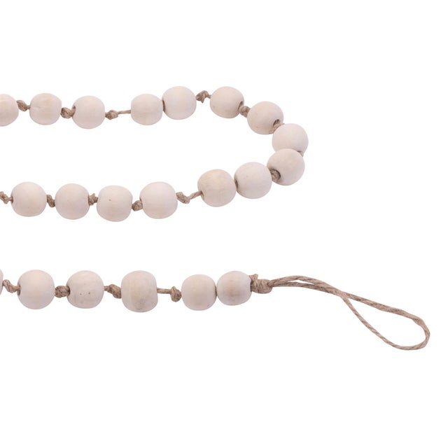 Bring a touch of rustic charm to your holiday decor with the Wood Beaded String Garland. Featuring wintry white tones and...