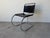 Iconic 1960s Mies van der Rohe–style cantilever chair featuring a sleek tubular chrome frame paired with a black leather...
