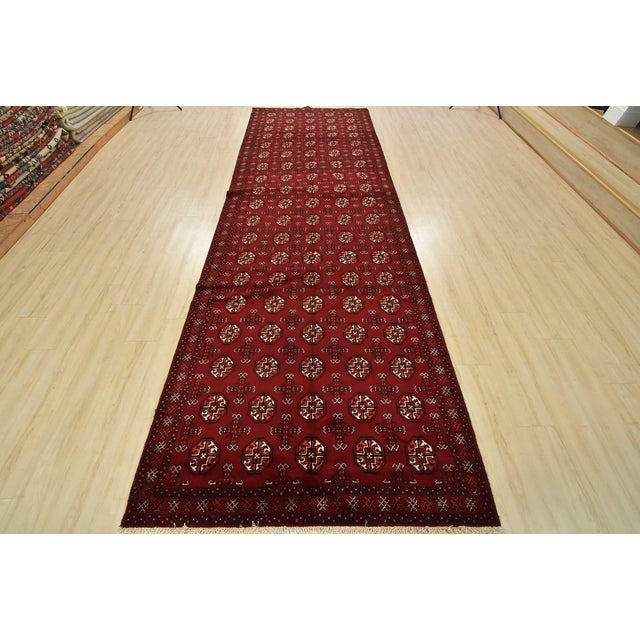An authentic vintage tribal Baloch runner hand-knotted with fine wool and natural dyes. This nomadic rug features a...