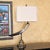 Distinctive vintage table lamp featuring a sculptural faux animal horn mounted on an ornate brass-tone metal pedestal and...