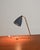 Fluted brass frame with an adjustable conical shade in painted metal and perforated edge. Designed by Eric Wärnå, Sweden,...