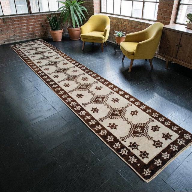 Woven on a village family loom in Eastern Anatolia during the 1960s, this extra-long runner rug reflects a rich weaving...