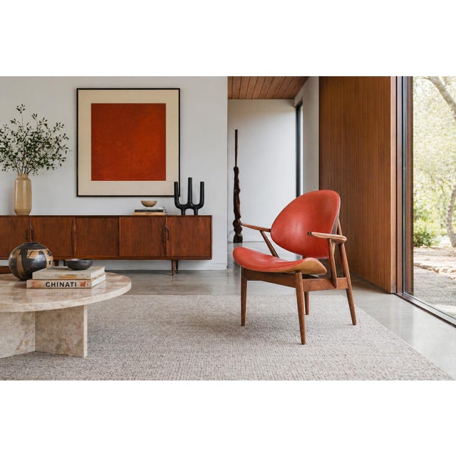 A true statement piece from the 1960s, this iconic vintage “Clam Shell” armchair by Seymour J. Wiener for Kodawood...