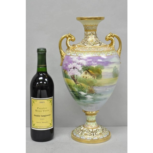 Antique Nippon Hand Painted "Cottage Lake Scene with Swans" Porcelain Twin Handle Bolted Urn Vase. Circa Early 20th...