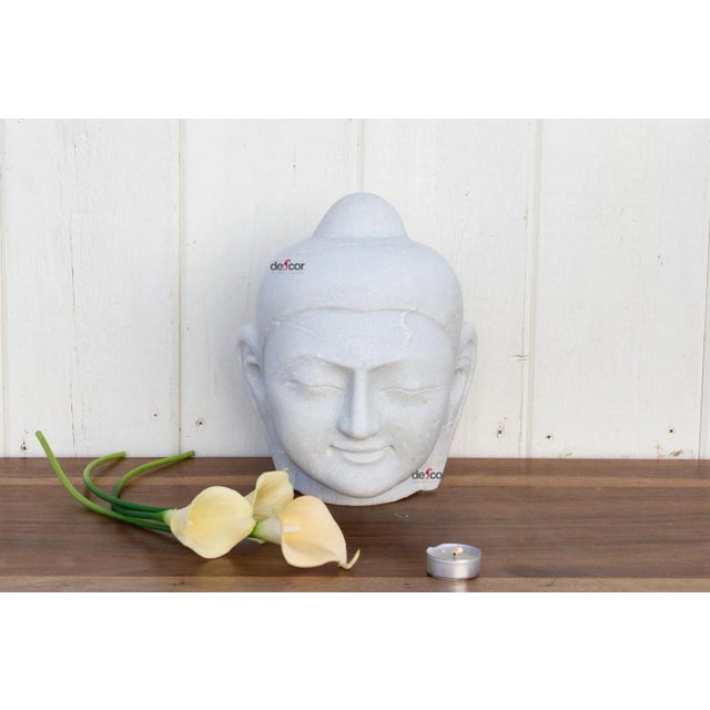This contemporary Buddha is hand-carved from pure white marble and shows beautifully carved facial features. This stunning...
