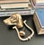 A solid brass dog door knocker with a sculptural hound or sporting-dog head, warm aged patina, and classic estate-style...