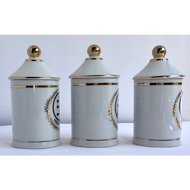 This is an amazing set of three apothecary jars with gold gilding and Japanese and English identifiers. They each measure...