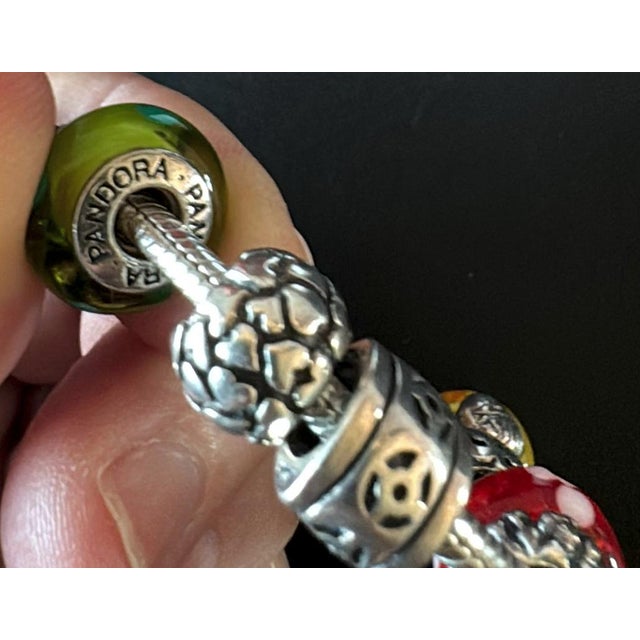 100% Authentic Pandora Silver Bracelet with 17 Multicolor Charms. Beautiful Pandora bracelet with 17 charms. The charms...