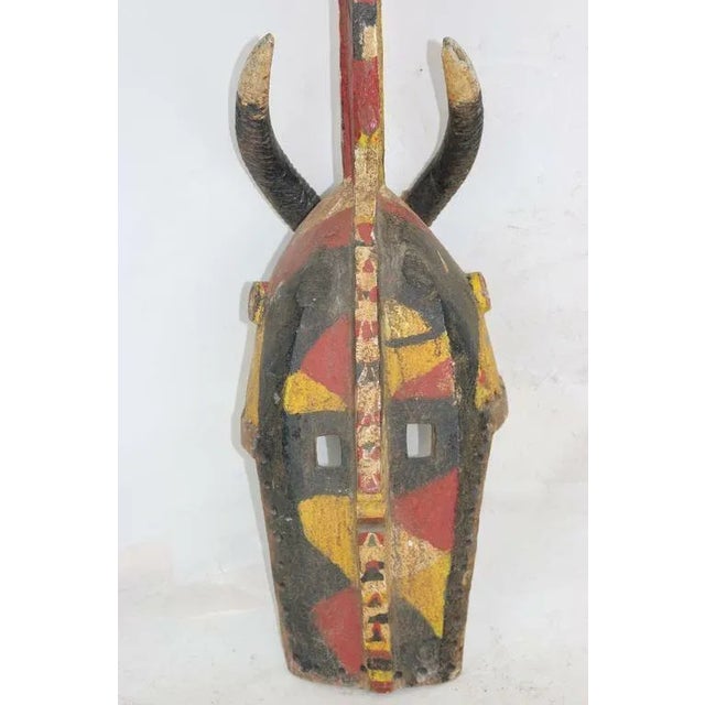 Stunning Large polychromed mask- Yellow, red, beige, black-primitive in nature with an aesthetic befitting a power space....
