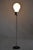 This elegant floor lamp from the 1960s is an iconic example of Mid-Century design originating from Germany. The...
